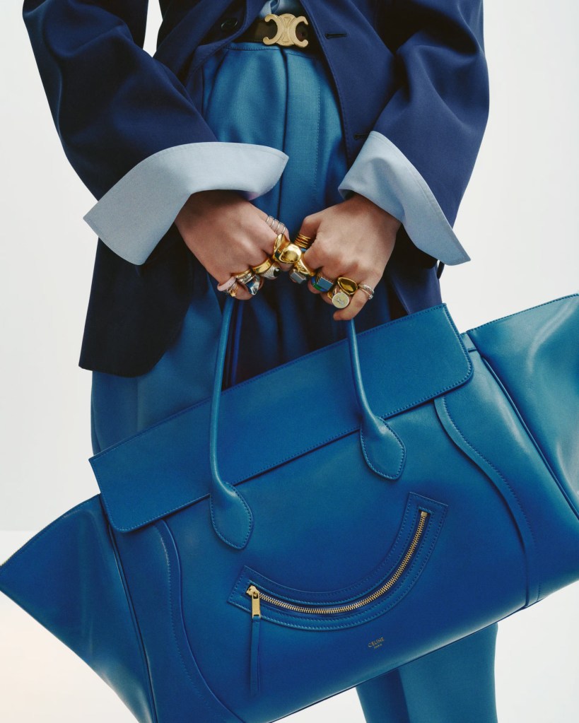 celine luxury fashion cobalt blue gold rings hands purse tote leather lvmh