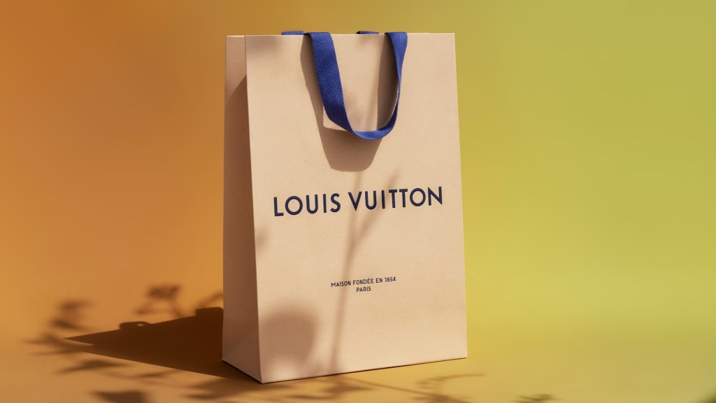louis vuitton white shopping bag luxury fashion green orange brand logo consumerism